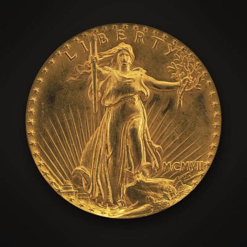 20 dollars or Saint-Gaudens haut relief de 1907, avers : la Liberté en marche, flambeau et rameau d’olivier, devant le soleil et le Capitole